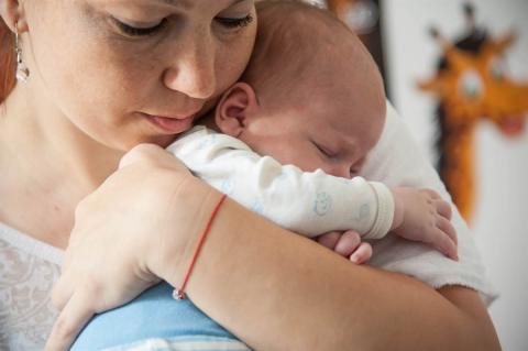  A mother holding a baby in her hands 