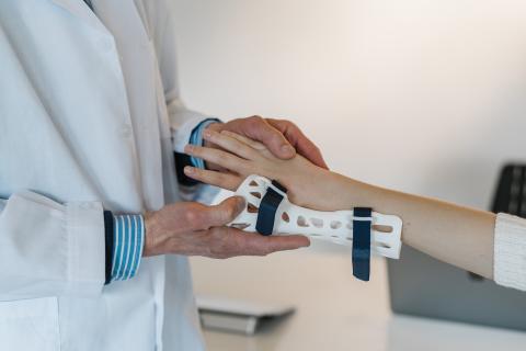 a doctor fixing strains, sprains, dislocations and fractures