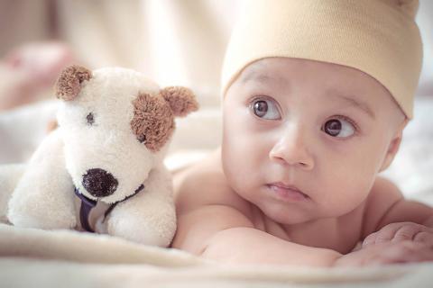 A new-born baby looking attentively somewhere