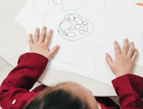 A child drawing bubbles