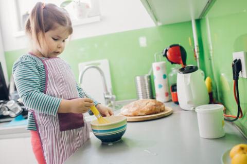 A child helping to prepare the meal