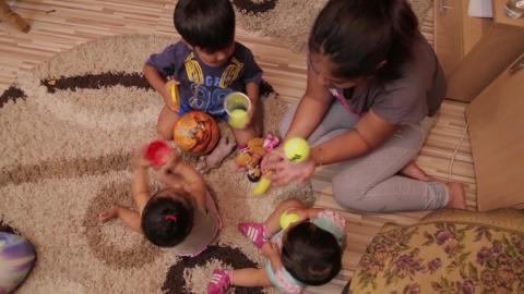 Children playing all together on the carpet 
