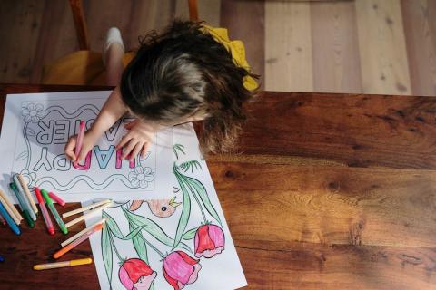 A chid drawing a card