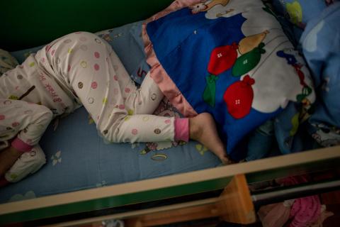 Toddler in sleeping in bed.