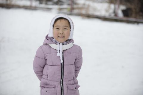 Girl paying in the snow.