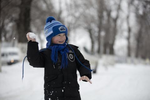 Boy playing in the snow.
