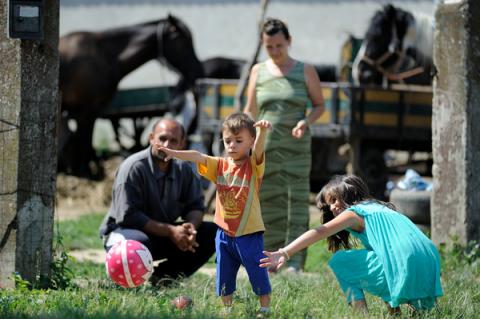 A family is playing in their front yard – father Zoran, mother Zorica and their children David (4 years old) and Aleksandra (9 years old).