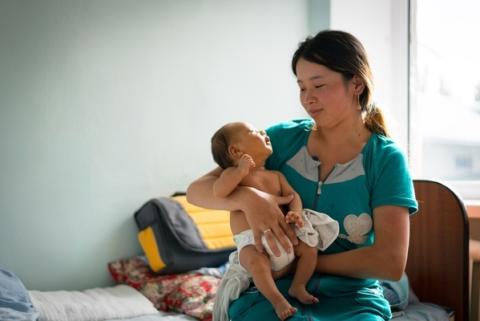 Boy (1.5 months) in his mothers arms at a hospital in Kyrgyzstan.