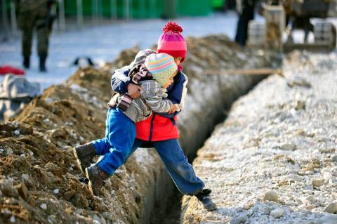 Siblings helping each other.