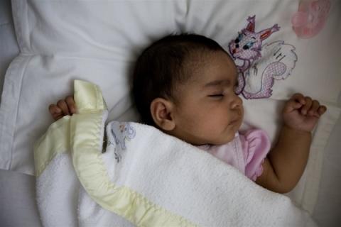 Baby sleeps in the home of her foster mother