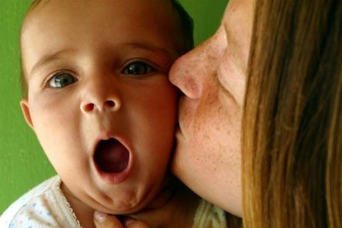 Mother with her baby giving him positive attention.
