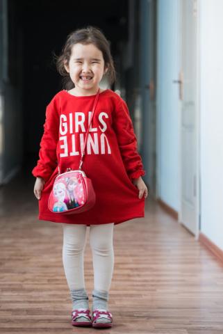 Zhansulu (5 years) os showing her dress.