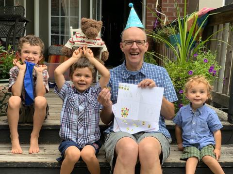 A father and three children at a birthday party