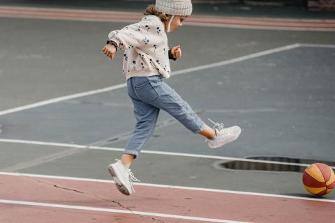 A girl kicking the ball