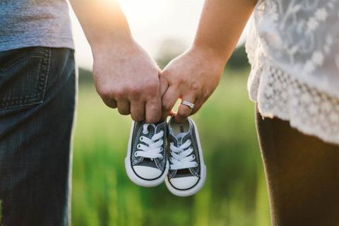 Mother father holding hands