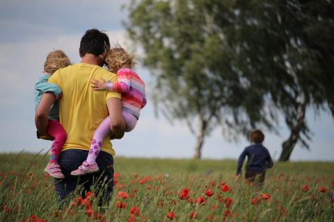 Father with daughters and son outside