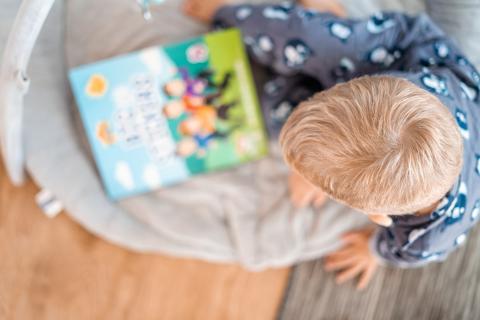 toddler playing at home reading