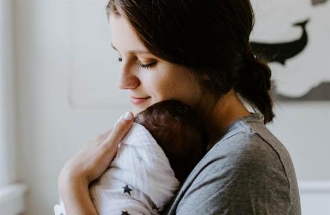 Mother holds her daughter