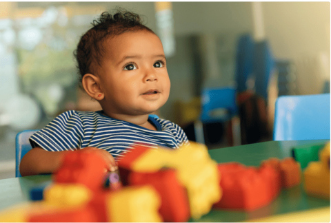 A child surrounded by colourful cubes