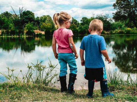 Children playing in the edge of a lake.