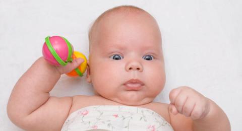A child holding his or her rattle