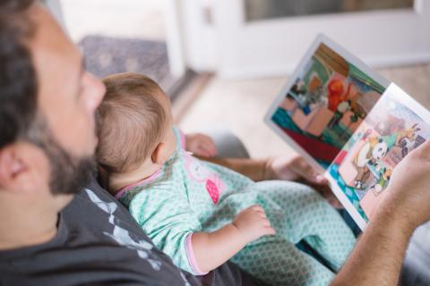 Father reading to his baby.