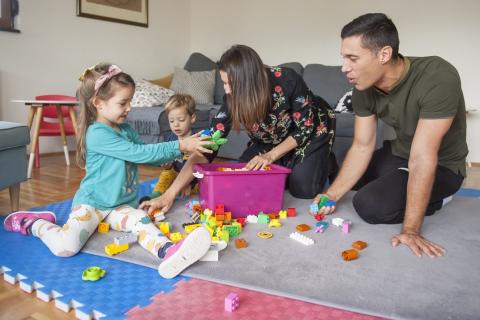 Parents and two kids playing all together 