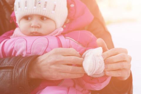 A baby wearing a winter clothes