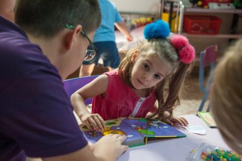 Child with developmental delay working with a professional