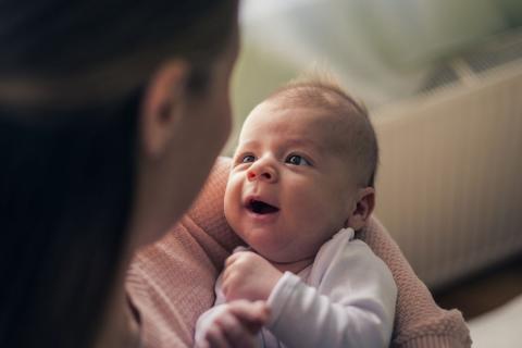 A mother and her child are happily looking at each other