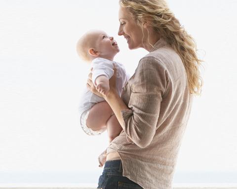 A mother and a child smiling at each other