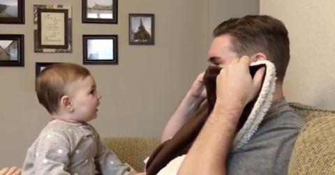 A father looking at his child and covering his face with the scarf