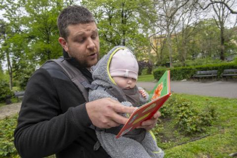 A father showing pictures to his baby