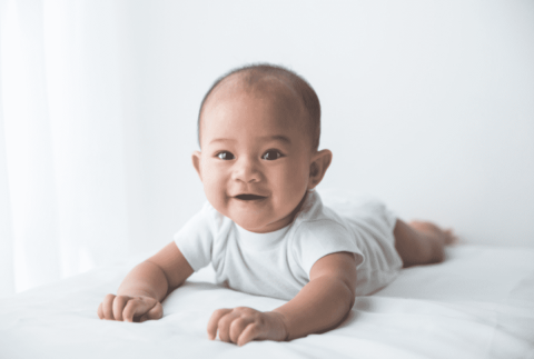 A child laying on her/his tummy