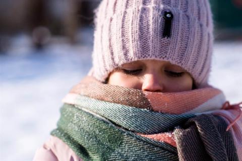 A child in winter wearing winter clothes