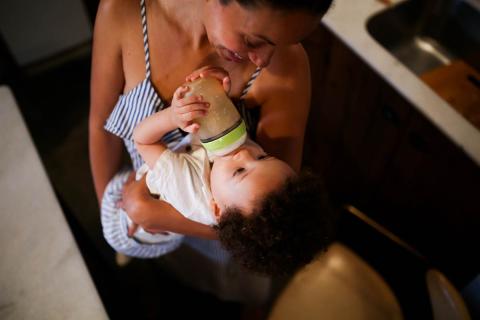 Mother feeding baby from a bottle