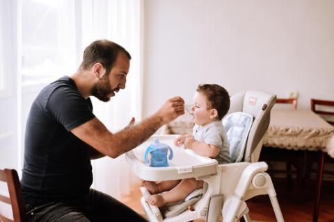 father feeding baby formula