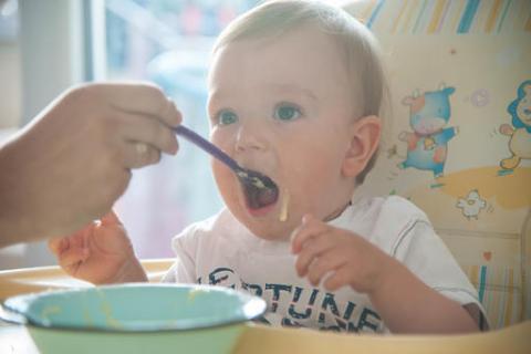 baby being fed by spoon