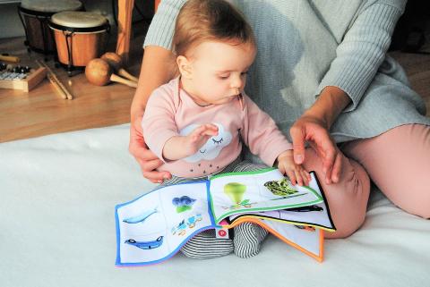 mother reading to her baby