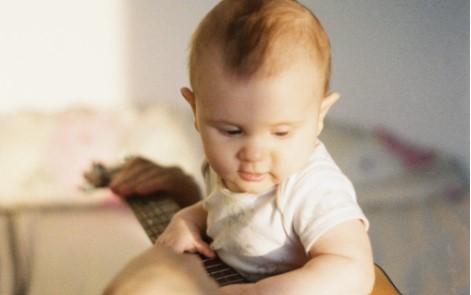 baby plucking guitar strings