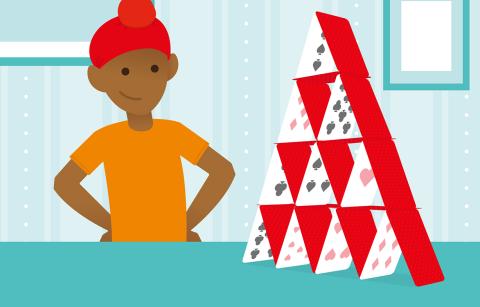 cartoon boy looking proud at his house of cards