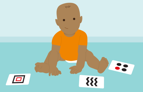 cartoon baby sitting next to cards with patterns on them