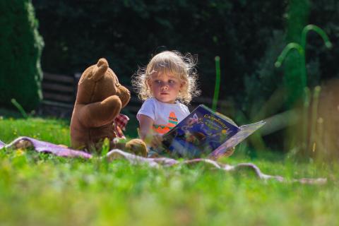 child reading to her teddy