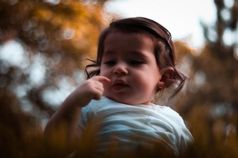 toddler pointing at own face