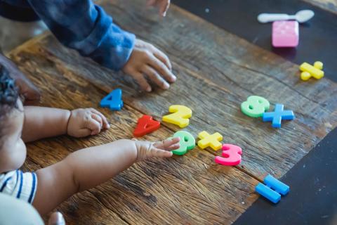 baby reaching for numbers