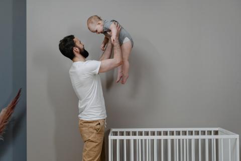 father lifting up baby