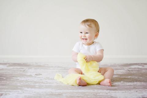 baby holding cotton cloth