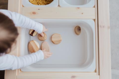 child grabbing things from a box