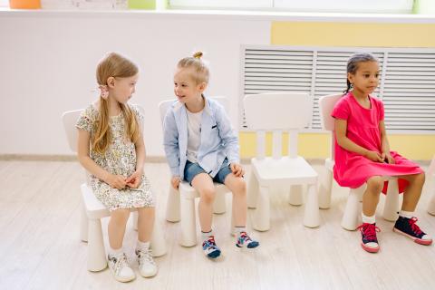 children sitting on chairs