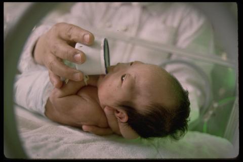 Baby being fed with a cup